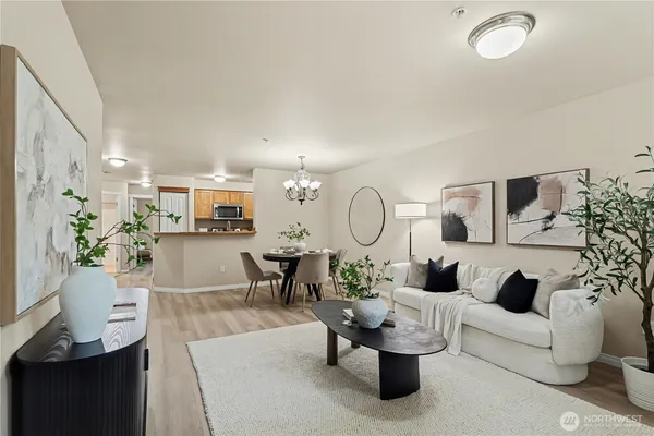 a living room with furniture a rug and white walls