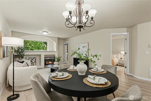 a view of a dining room with furniture a chandelier and wooden floor