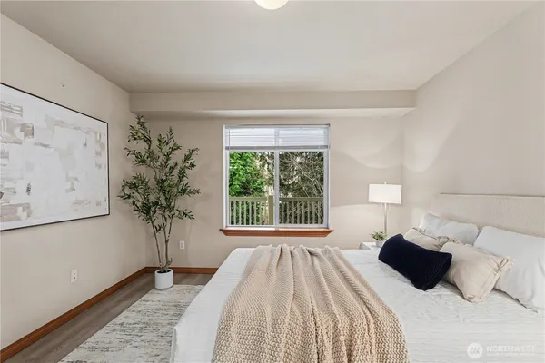 a bedroom with a large bed and a window