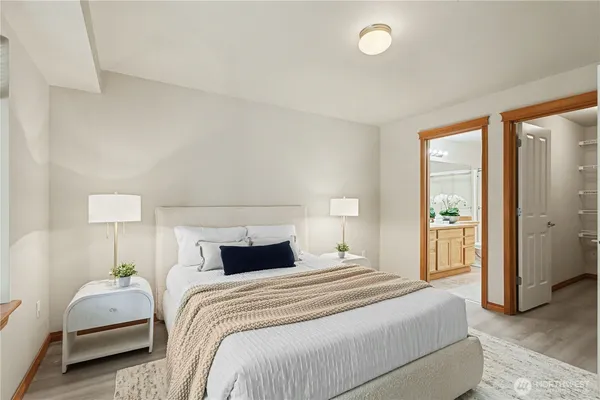 a bedroom with bed and a night stand