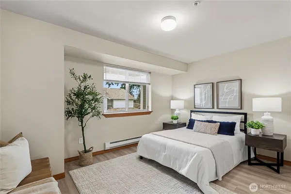 a bedroom with a bed and a potted plant