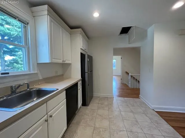 a kitchen with a sink and cabinets