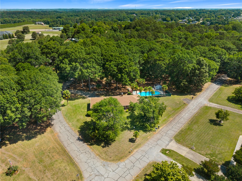 2101 Old Spring Drive Anderson, SC 29625 - Photo 30 of 36 An aerial perspective showcases a property with a private pool nestled amidst mature trees and green expanses.