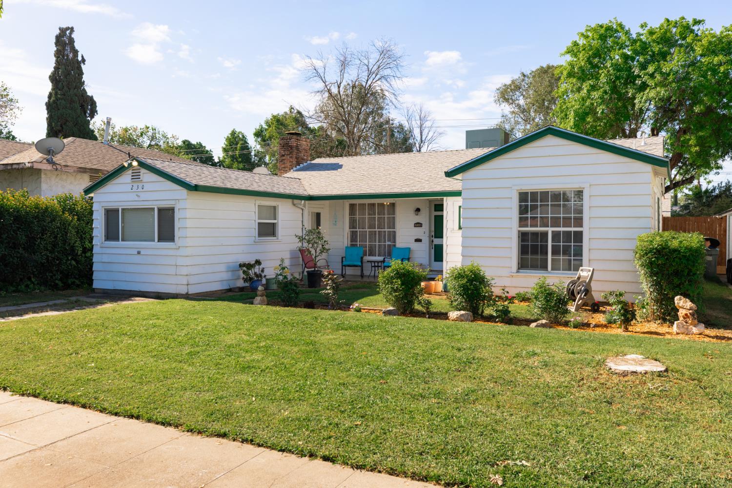 230 West 25th Street Merced, CA 95340 - Photo 1 of 20 a front view of a house with a yard and garage