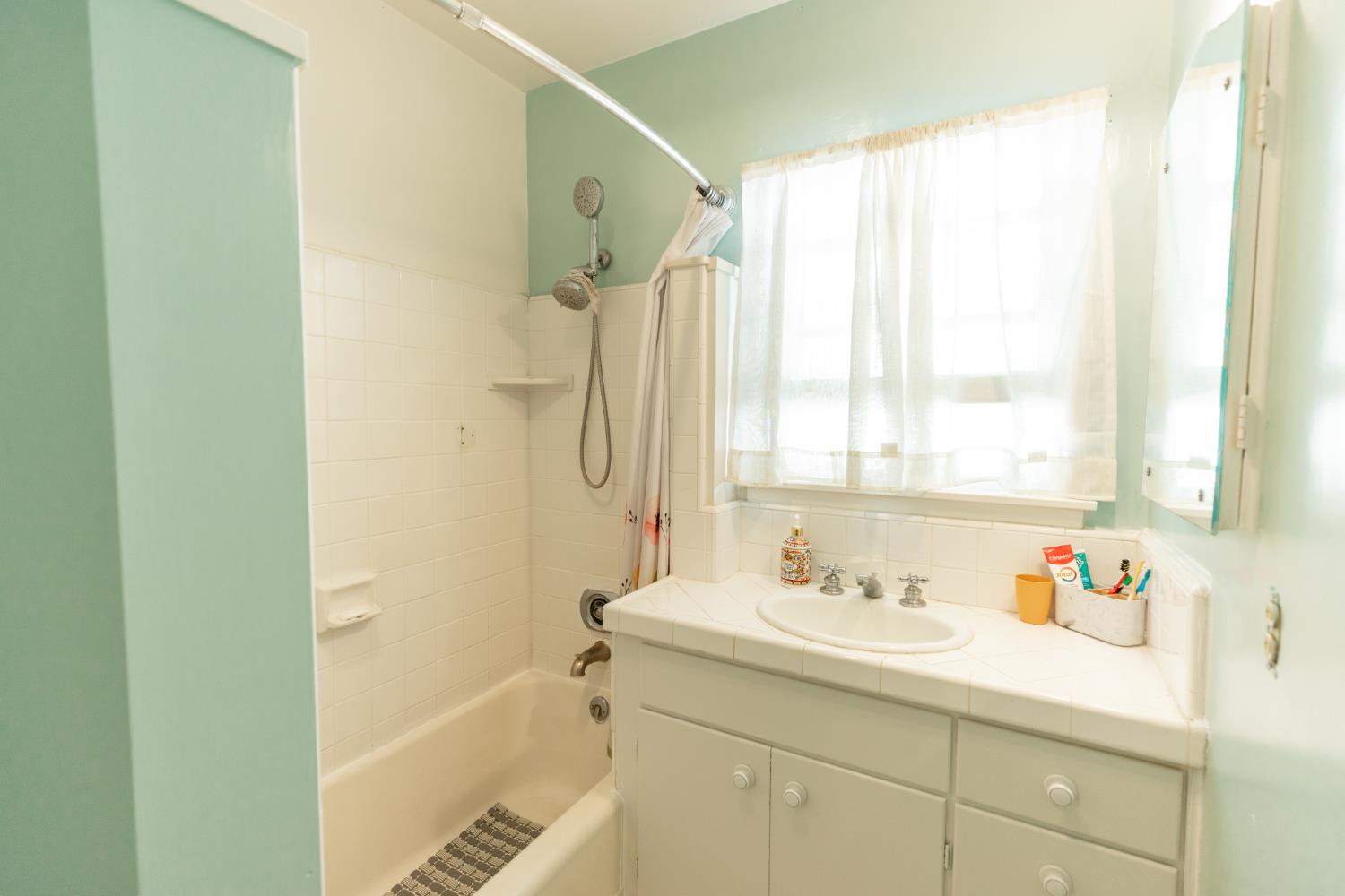 230 West 25th Street Merced, CA 95340 - Photo 11 of 20 a bathroom with a tub sink and mirror