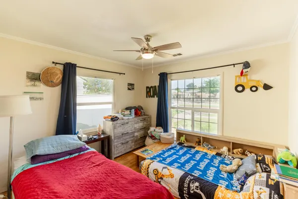 a bedroom with two beds and a window