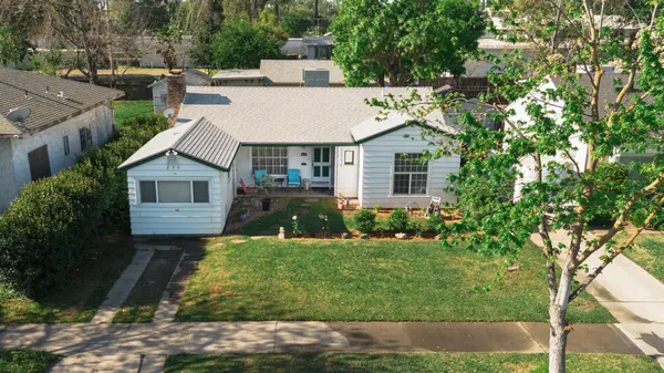 a aerial view of a house next to a yard