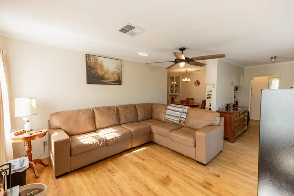 a living room with furniture and a chandelier