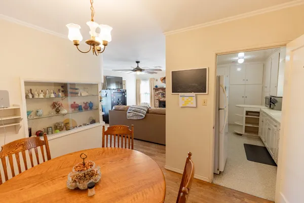 a living room with kitchen island furniture and a chandelier