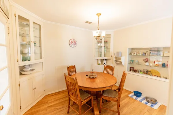 a view of a dining room with furniture and chandelier