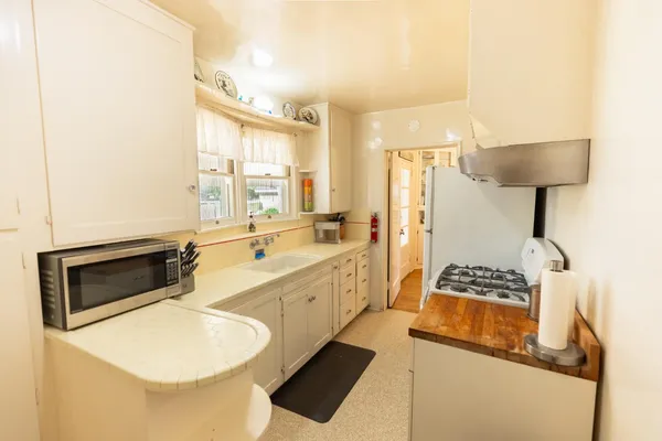 a spacious bathroom with a granite countertop sink and a mirror