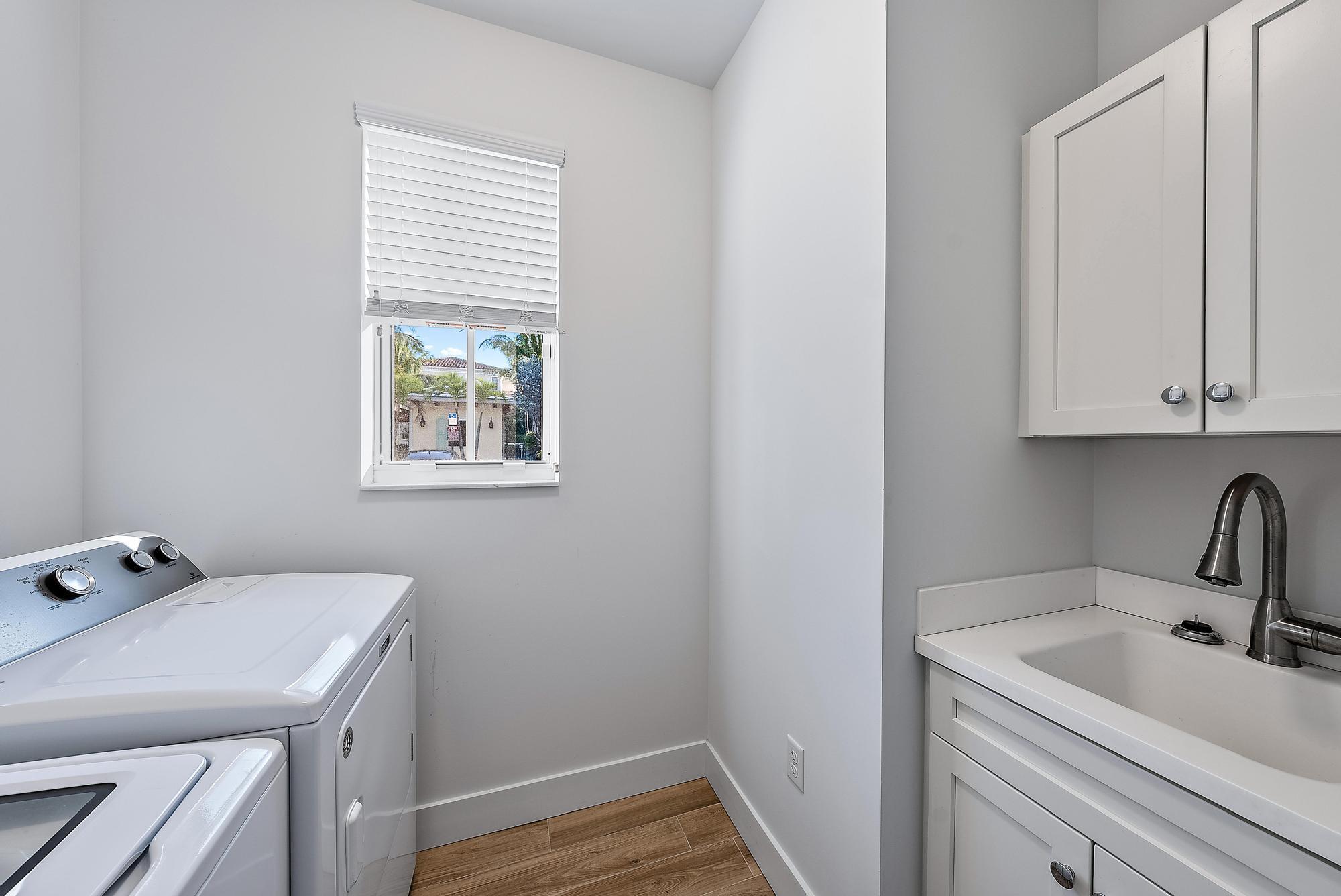 3770 County Line Road Tequesta, FL 33469 - Photo 15 of 42 a bathroom with a sink and a window