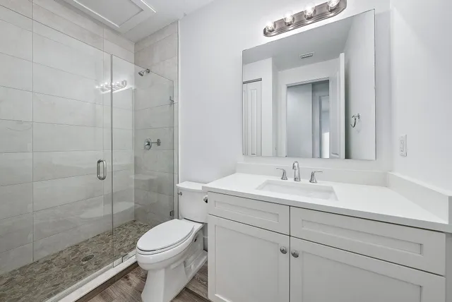 a bathroom with a toilet sink shower and mirror
