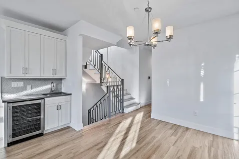 a view of a kitchen with furniture and wooden floor