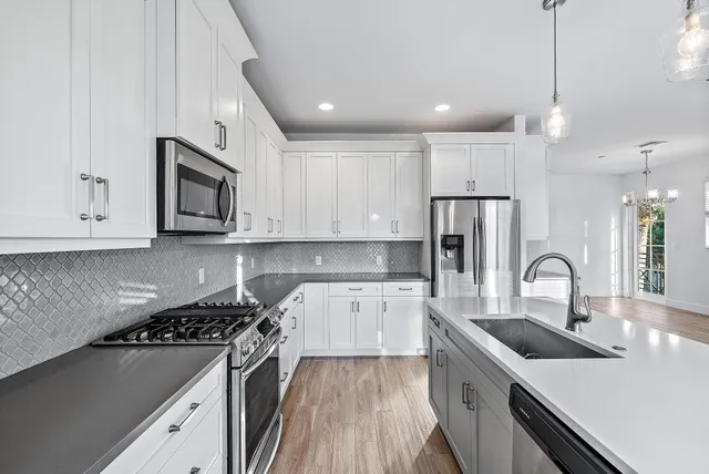 a kitchen with a sink stove and refrigerator