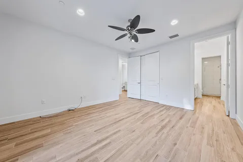 a view of an empty room and wooden floor