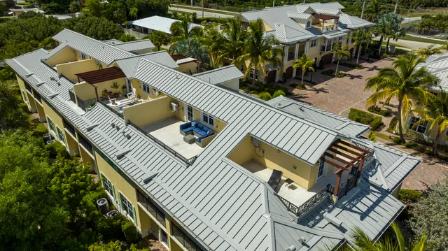 an aerial view of a house with balcony and patio