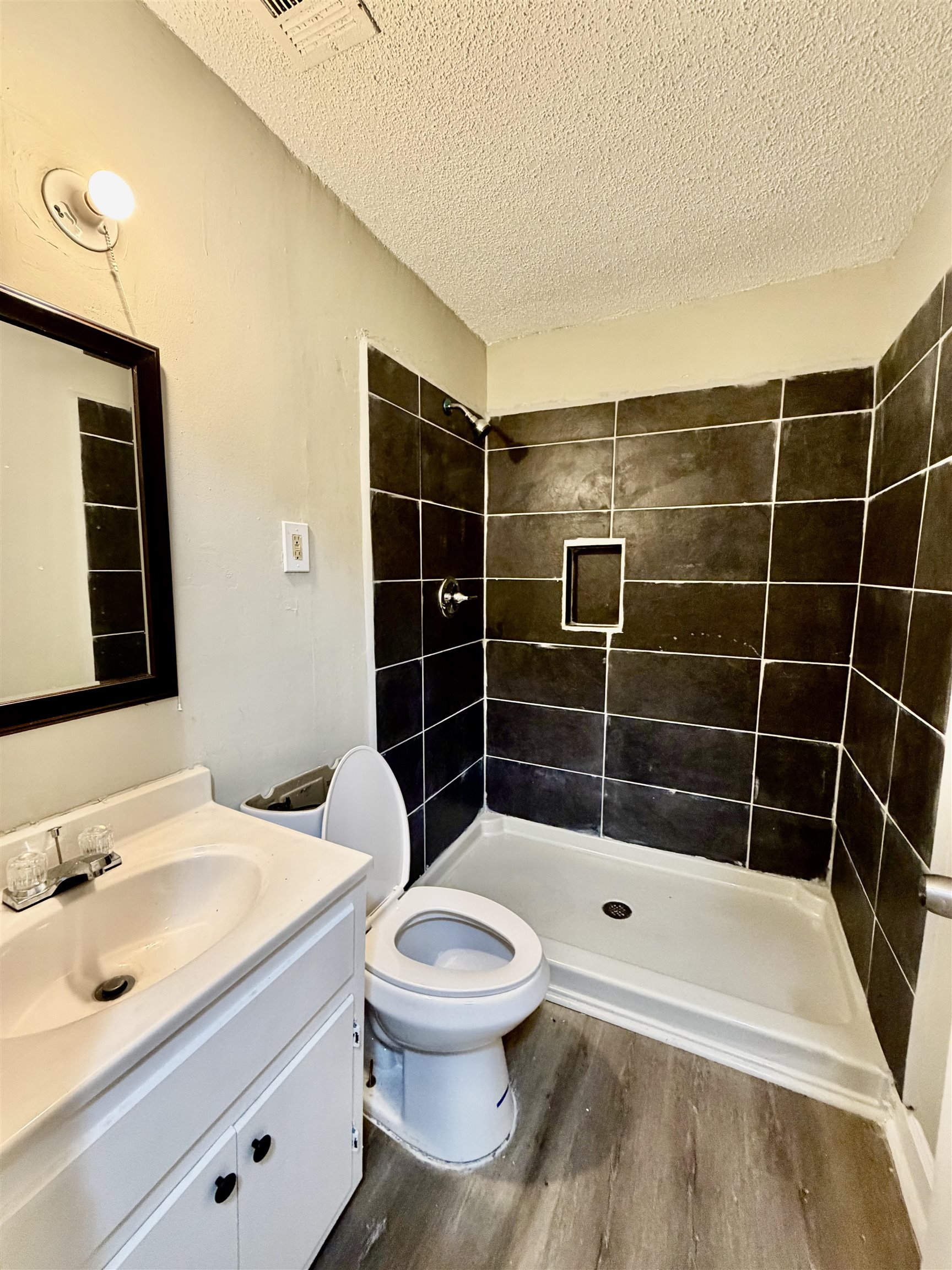 1448 Menager Road Memphis, TN 38106 - Photo 12 of 17 a bathroom with a toilet a sink and shower