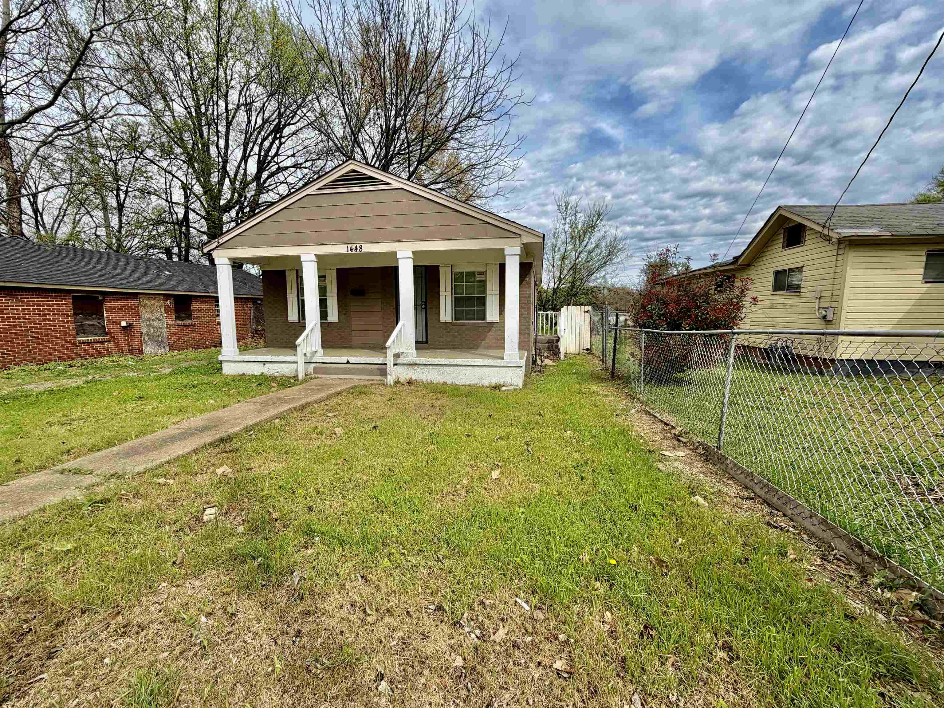 1448 Menager Road Memphis, TN 38106 - Photo 2 of 17 a front view of a house with a yard