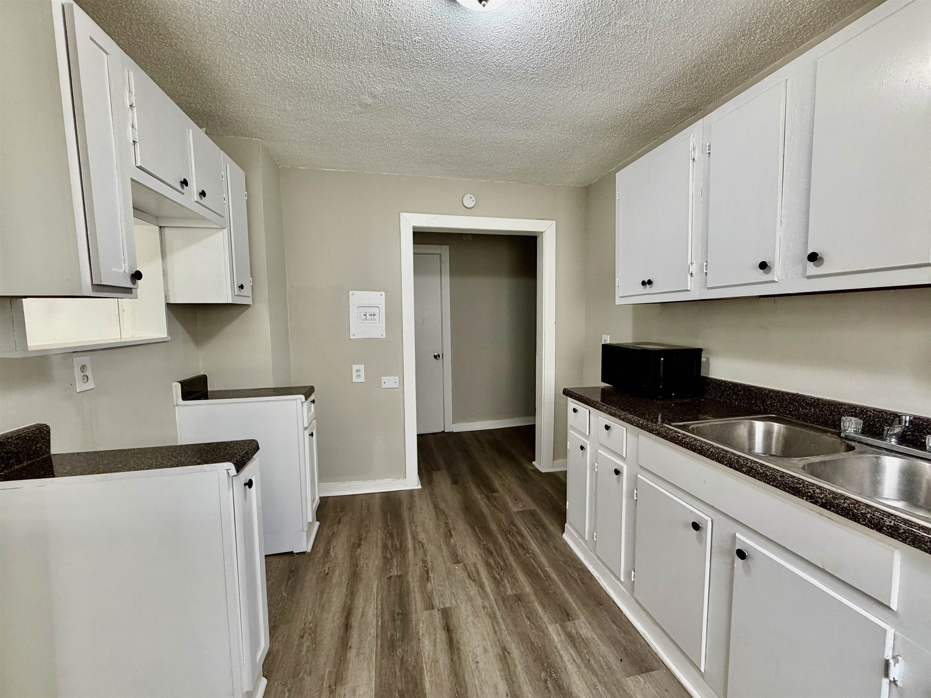 1448 Menager Road Memphis, TN 38106 - Photo 4 of 17 a kitchen with white cabinets and sink