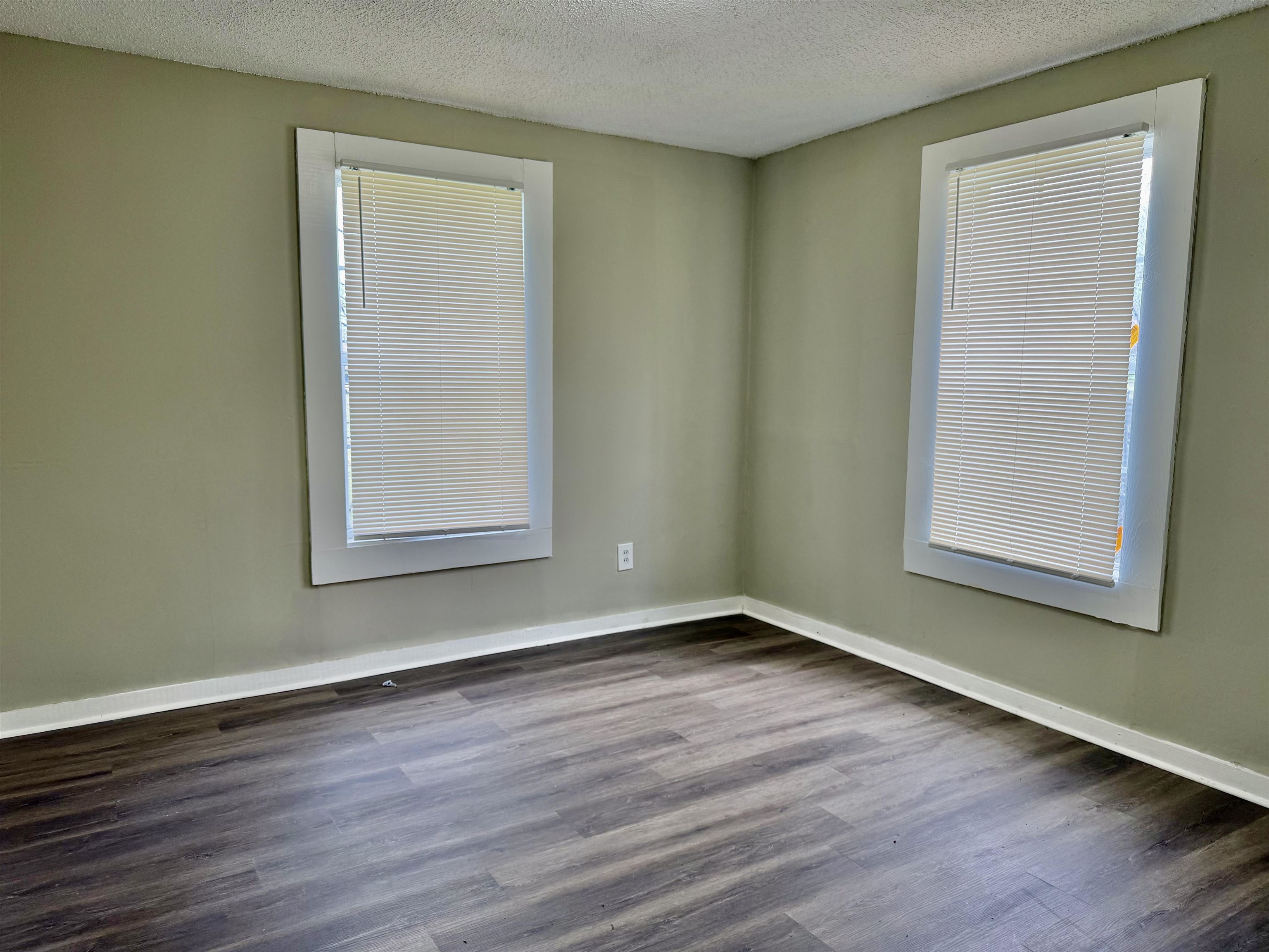 1448 Menager Road Memphis, TN 38106 - Photo 9 of 17 a view of an empty room with wooden floor and a window