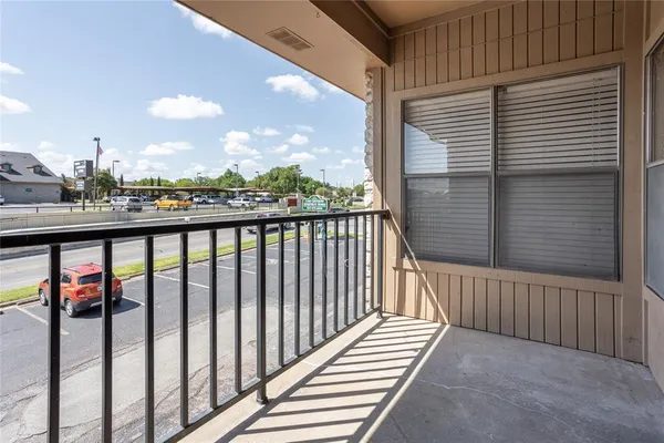 a view of a balcony with wooden floor