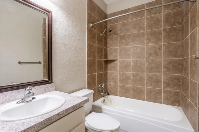 a bathroom with a sink a toilet and bathtub