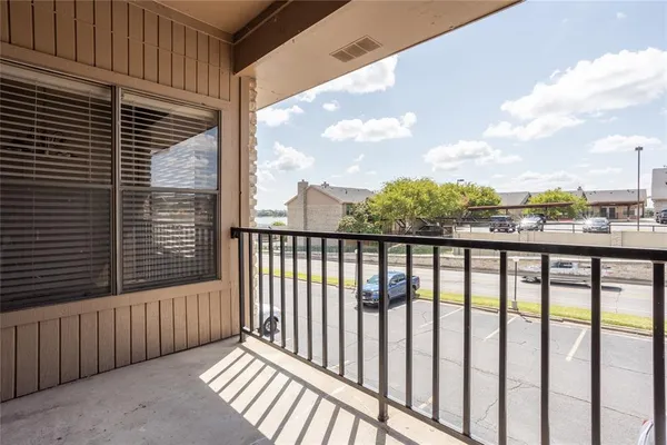 a view of a balcony with wooden fence