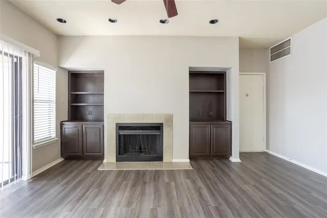a view of a livingroom with a fireplace and wooden floor