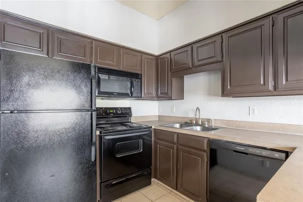 a kitchen with a sink stove and cabinets
