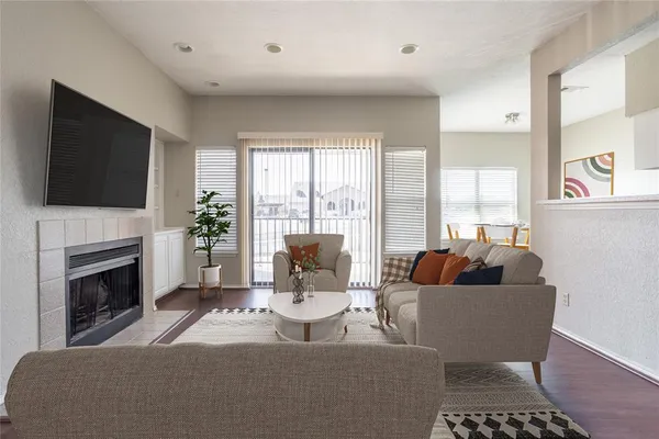 a living room with furniture a flat screen tv and a fireplace