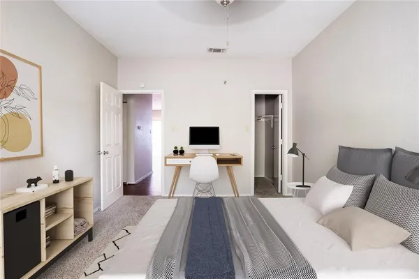 a bedroom with a large bed and a flat screen tv