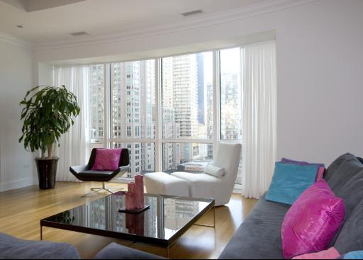 60 West Erie Street, Unit 1102 Chicago, IL 60654 - Photo 3 of 12 a living room with furniture and a large window