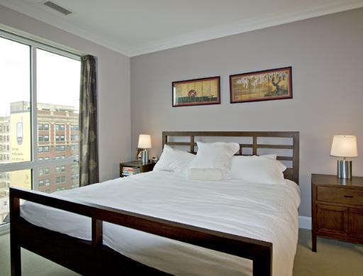 60 West Erie Street, Unit 1102 Chicago, IL 60654 - Photo 7 of 12 a bedroom with a large bed and a lamp on table