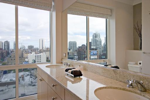 60 West Erie Street, Unit 1102 Chicago, IL 60654 - Photo 8 of 12 a bathroom with a granite countertop sink and a large window