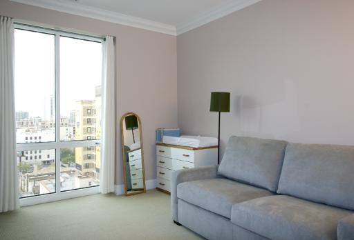 60 West Erie Street, Unit 1102 Chicago, IL 60654 - Photo 9 of 12 a living room with furniture and a large window