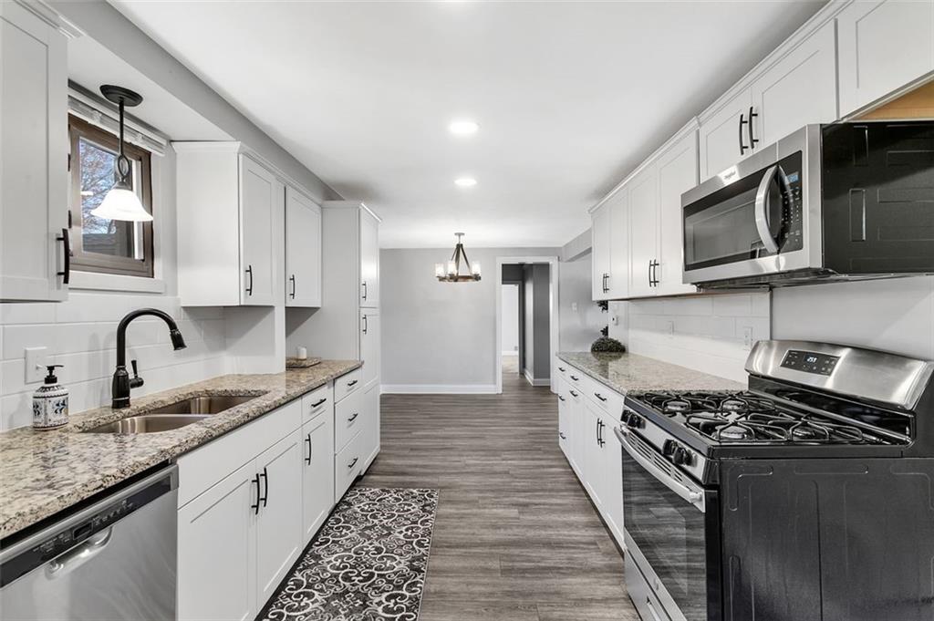 225 Houston Road Pittsburgh, PA 15237 - Photo 14 of 25 a large kitchen with stainless steel appliances granite countertop a stove and a sink