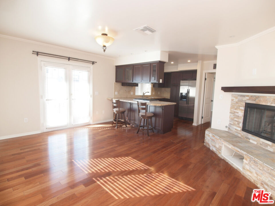 1644 Hi Point Street Los Angeles, CA 90035 - Photo 5 of 11 a living room with fireplace furniture and a wooden floor