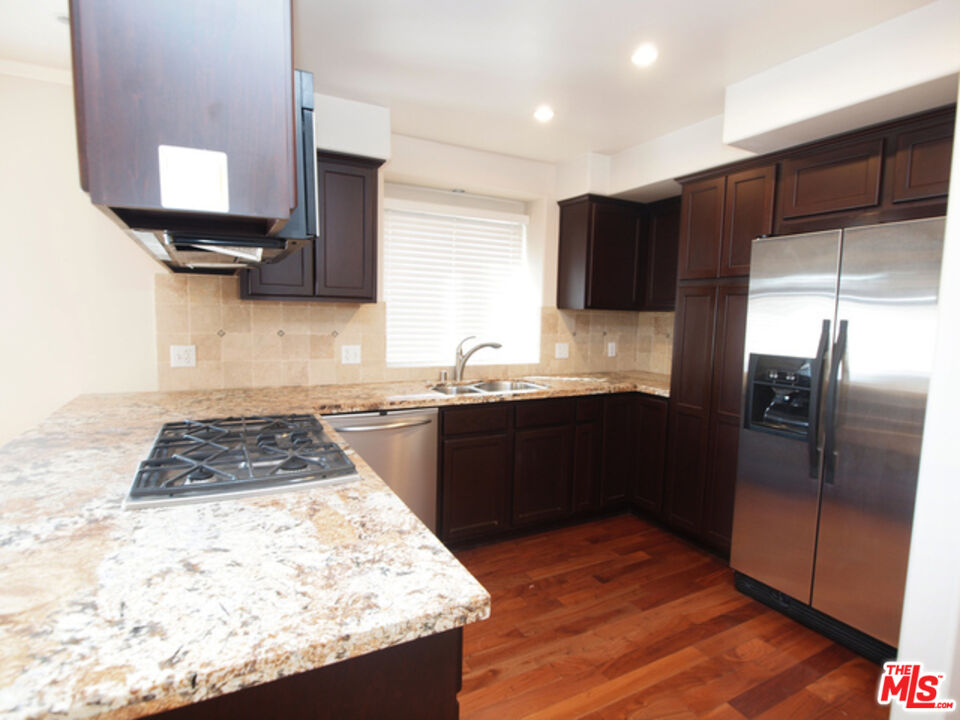 1644 Hi Point Street Los Angeles, CA 90035 - Photo 6 of 11 a kitchen with kitchen island granite countertop a refrigerator stove top oven and sink