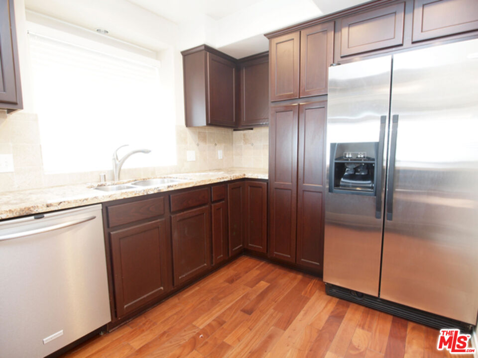 1644 Hi Point Street Los Angeles, CA 90035 - Photo 7 of 11 a kitchen with stainless steel appliances granite countertop a refrigerator and a sink
