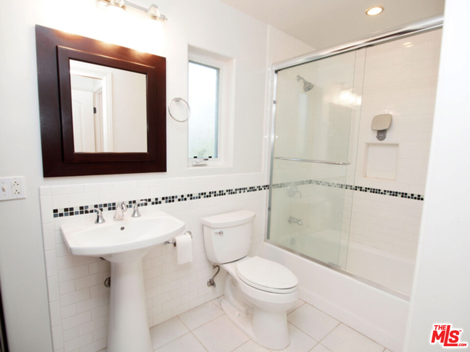 1644 Hi Point Street Los Angeles, CA 90035 - Photo 9 of 11 a bathroom with a toilet sink shower and mirror