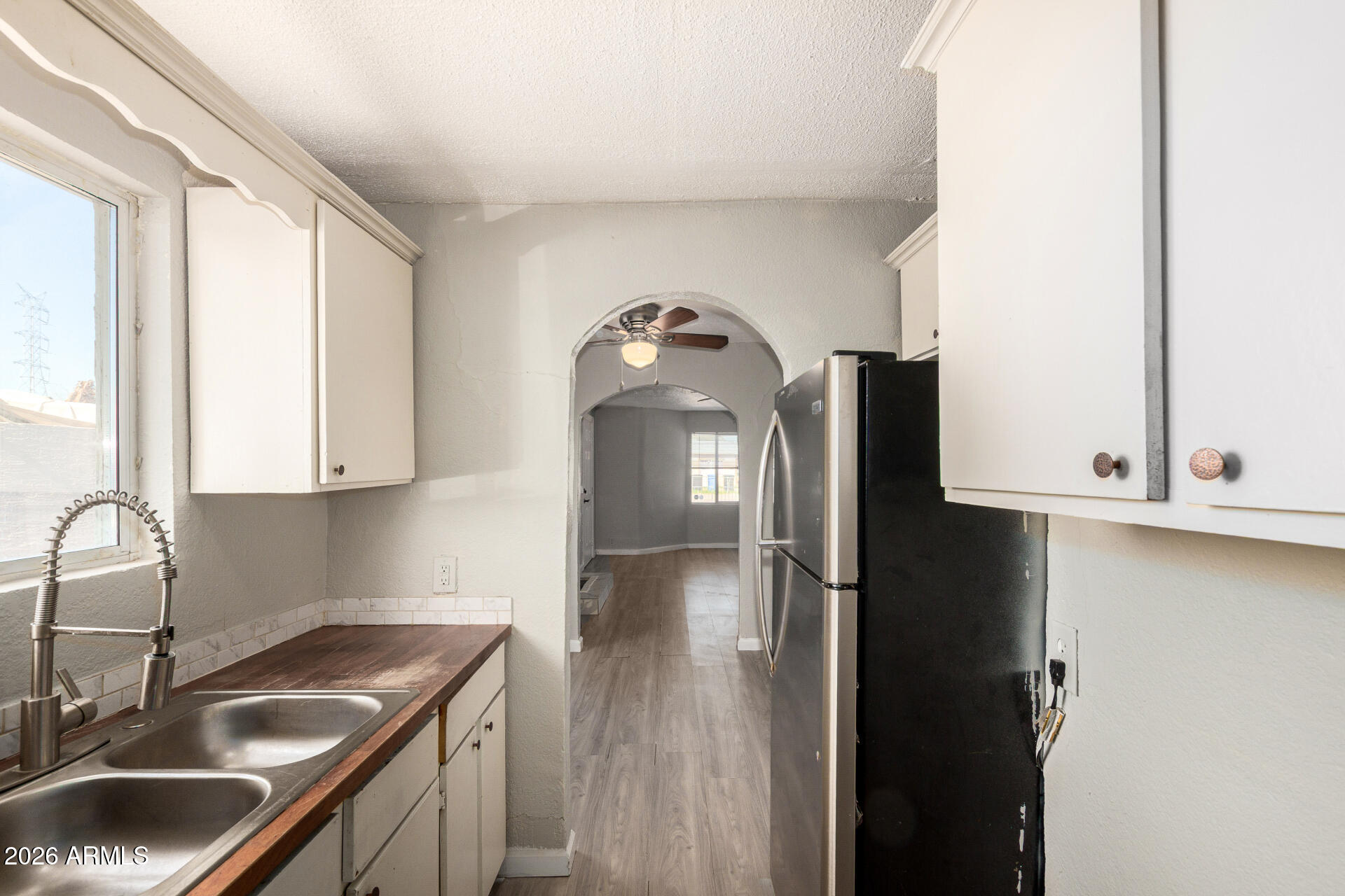2135 West Hadley Street, Unit 1 Phoenix, AZ 85009 - Photo 12 of 18 a kitchen with a sink a refrigerator and cabinets