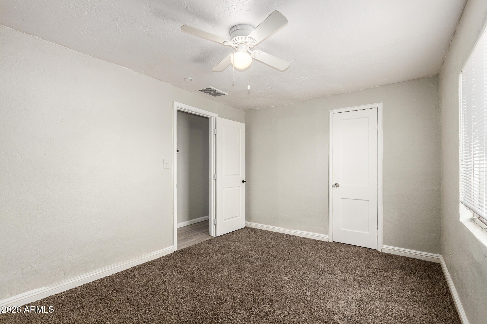 2135 West Hadley Street, Unit 1 Phoenix, AZ 85009 - Photo 14 of 18 a view of an empty room with a window