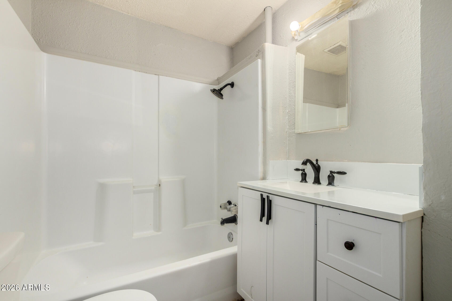 2135 West Hadley Street, Unit 1 Phoenix, AZ 85009 - Photo 15 of 18 a bathroom with a sink a toilet and shower