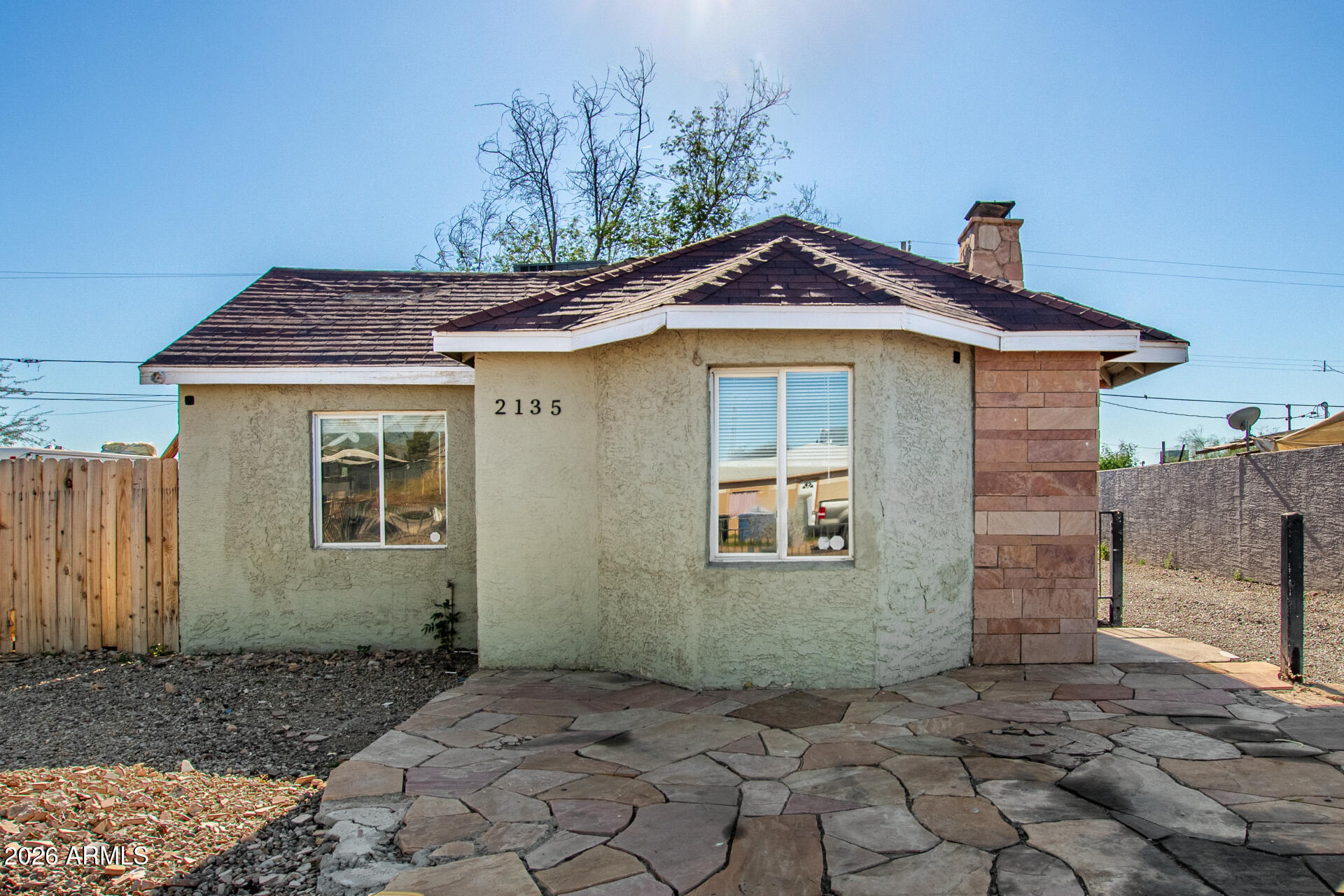2135 West Hadley Street, Unit 1 Phoenix, AZ 85009 - Photo 17 of 18 a front view of a house with a yard