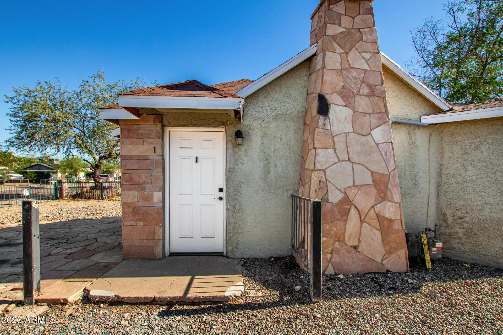 2135 West Hadley Street, Unit 1 Phoenix, AZ 85009 - Photo 3 of 18 a front view of a house with garden