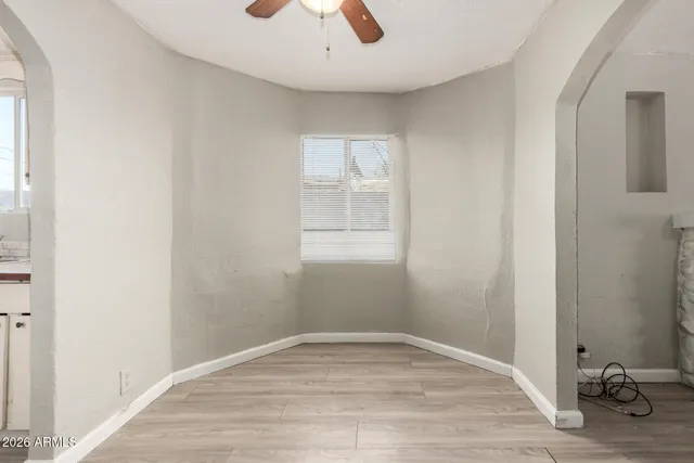 a view of empty room with wooden floor