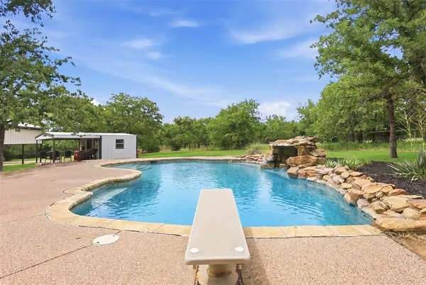 a view of a swimming pool with a chair