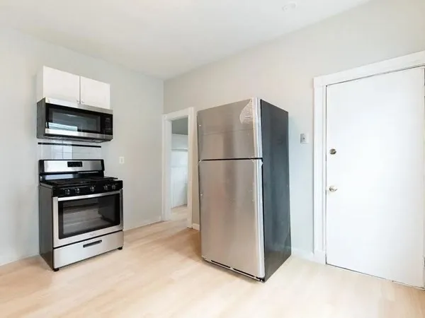 a kitchen with stainless steel appliances granite countertop a sink and a stove top oven
