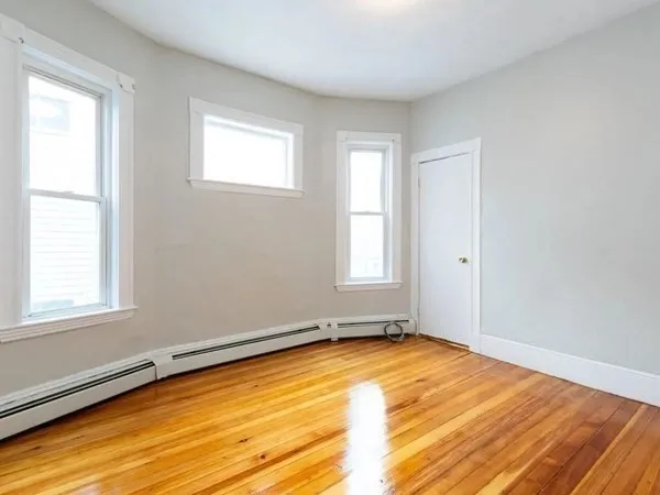 a view of a room with window and wooden floor